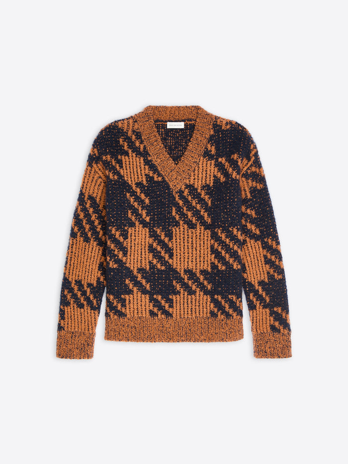 Light rust and navy checkered graphic sweater on a white background