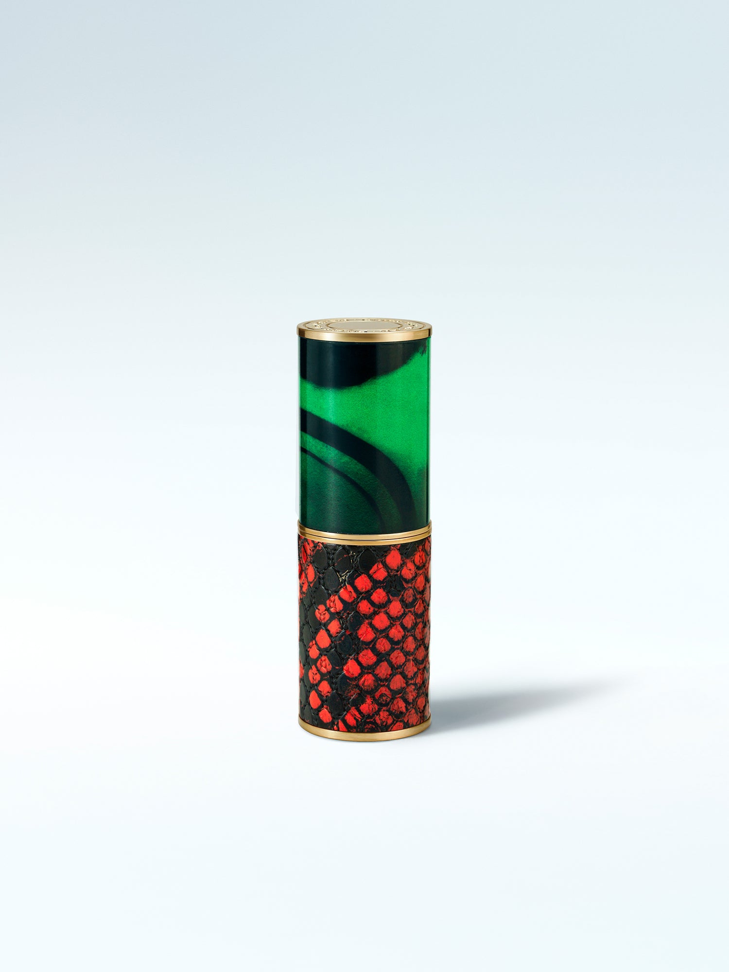 Cylindrical container with green, gold, and red design on a white background