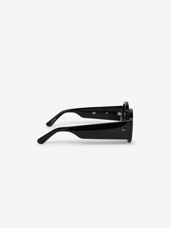 White container with a black lid on a white background