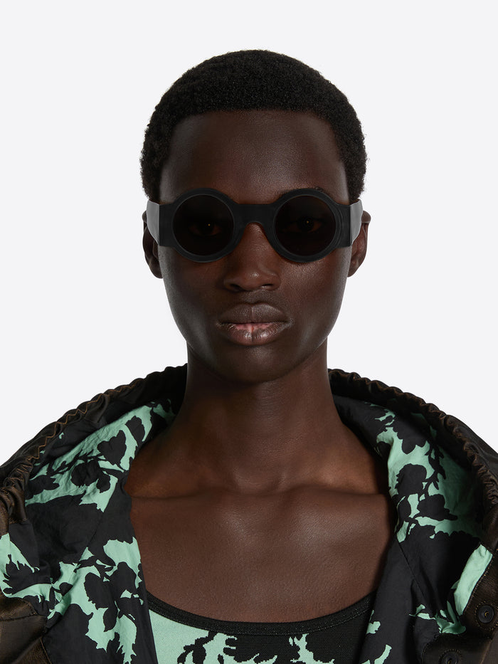 Person wearing a patterned jacket with a plain background