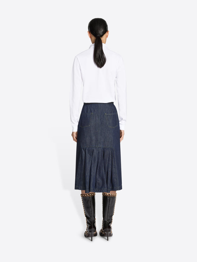 Women wearing a white blouse and blue denim elasticated midi skirt on a white background