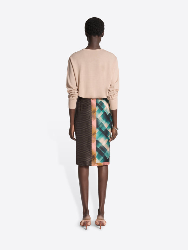 Person wearing a v-neck beige sweater on a white background