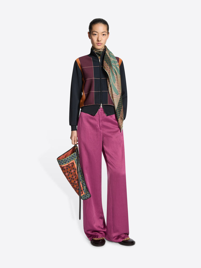 Person wearing a patterned scarf on a white background