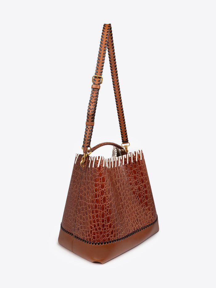 Brown leather handbag with textured pattern on a white background