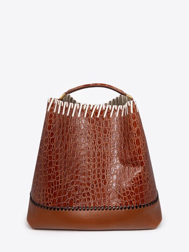 Brown leather bucket bag with a textured pattern on a white background