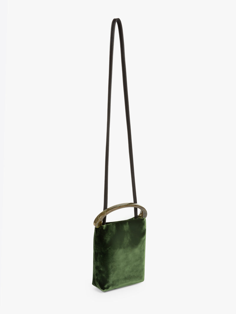 Green crossbody bag with a strap on a white background