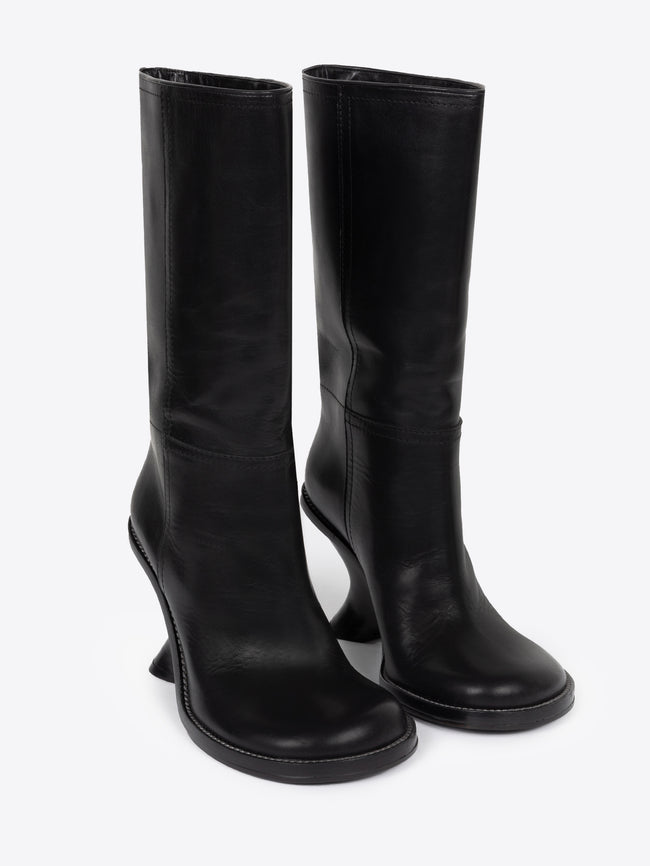 Pair of black leather wedge boots on a white background