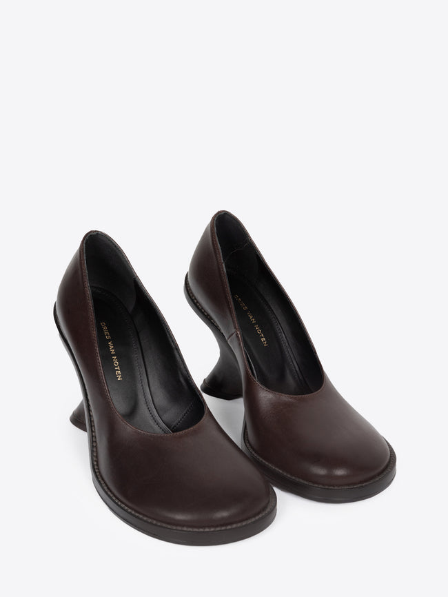 Pair of dark brown leather wedge pumps on a white background