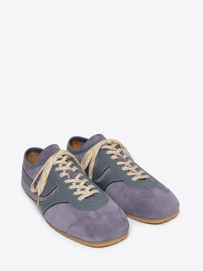 Pair of mauve suede sneakers on a white background