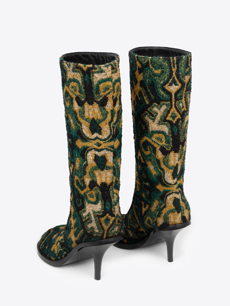 Backside of a pair of green, yellow and black patterned round-toe, stiletto heel jacquard boots on a white background