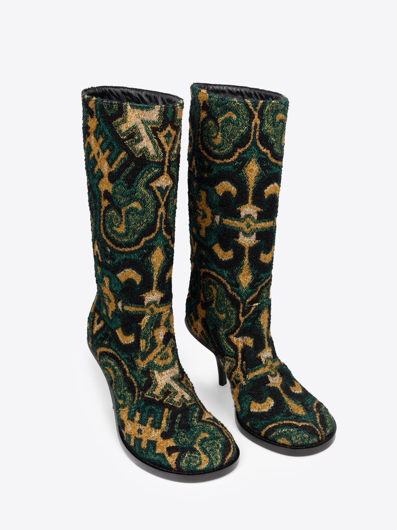 Pair of green, yellow and black patterned round-toe, stiletto heel jacquard boots on a white background
