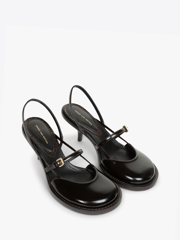 Black high-heeled shoes with thin straps on a white background