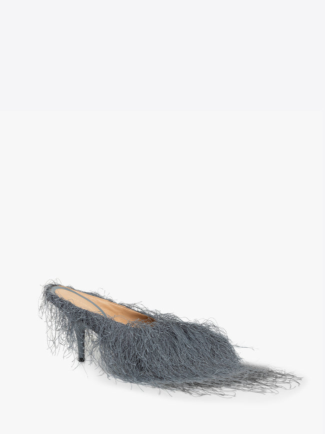 Gray high-heeled shoe with fringe details on a white background