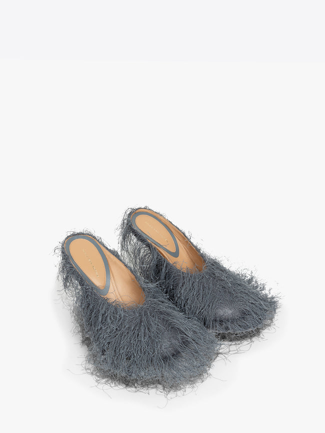 Pair of gray fluffy slippers on a white background
