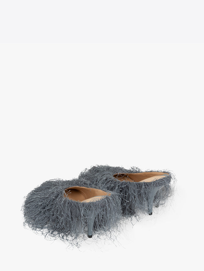 Pair of gray furry high-heeled shoes on a white background