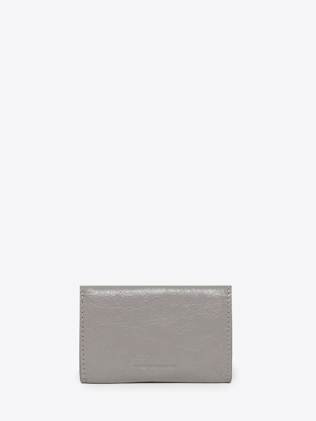 Backside of a light grey envelope-shaped cardholder on a white background