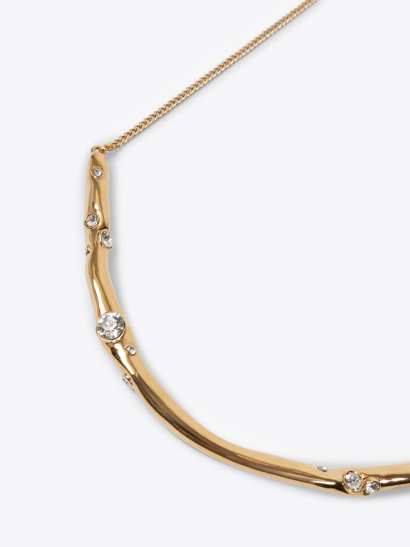 Gold necklace with small pearls on a white background