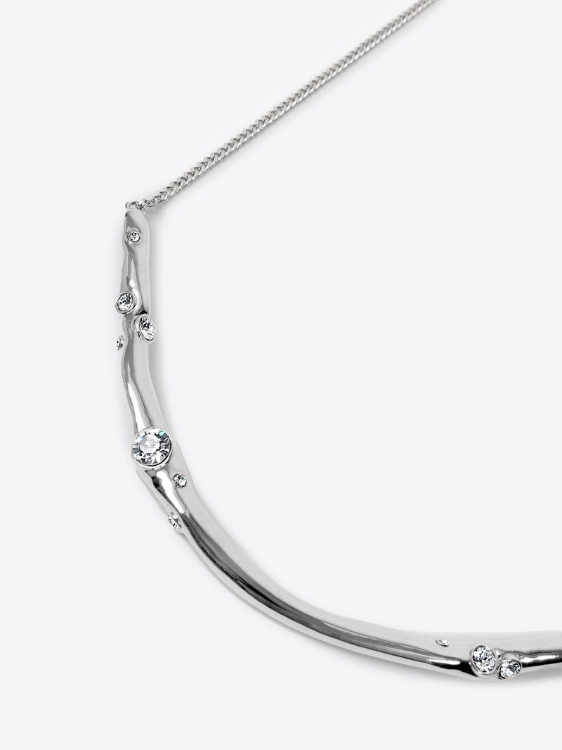Silver necklace with small round stones on a white background