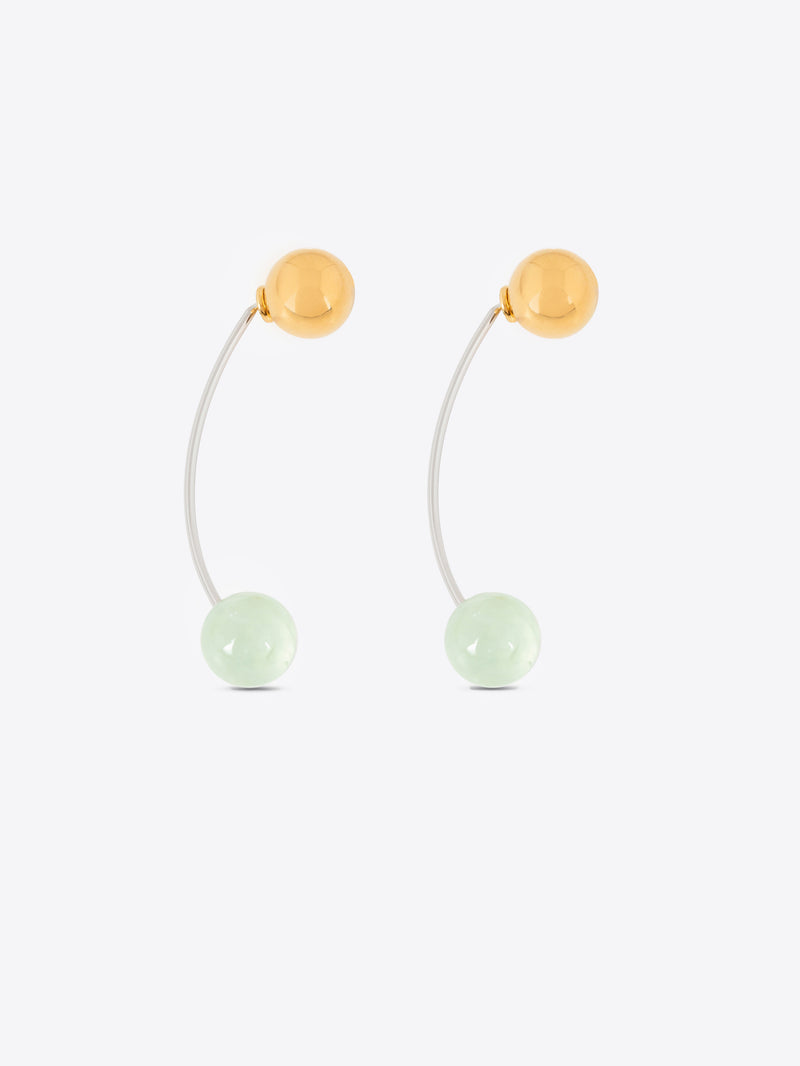 Pair of earrings with gold and green beads on a white background