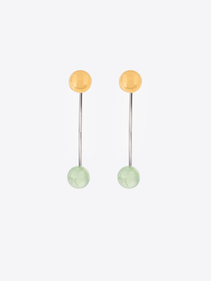 Pair of earrings with gold and green beads on a white background