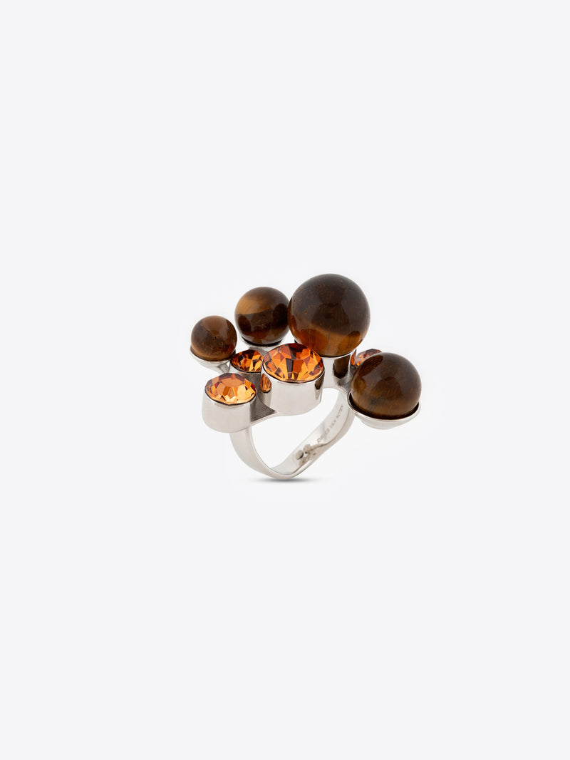 Silver ring with brown and orange gemstones on a white background