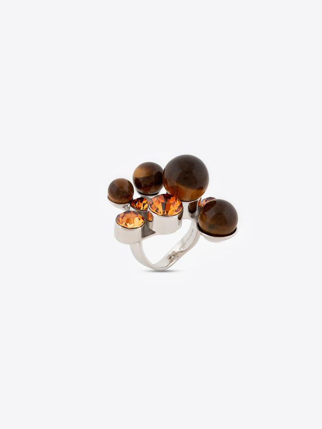 Silver ring with brown and orange gemstones on a white background