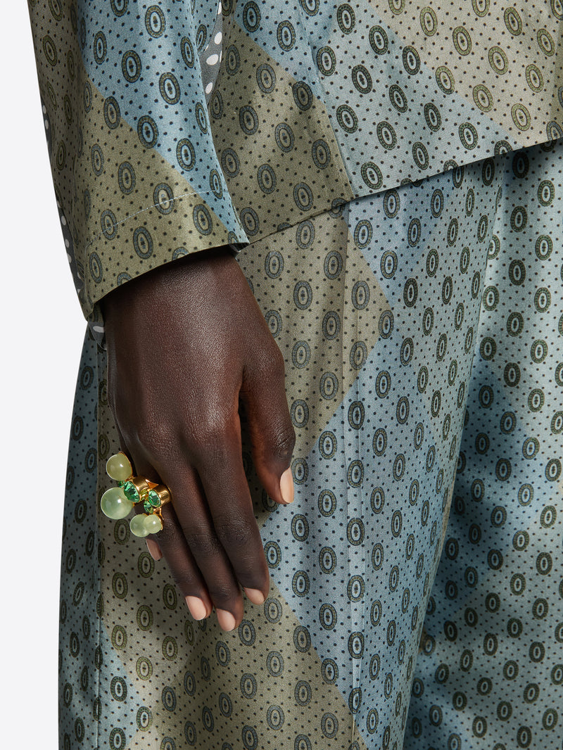 Patterned suit with a hand wearing a ring