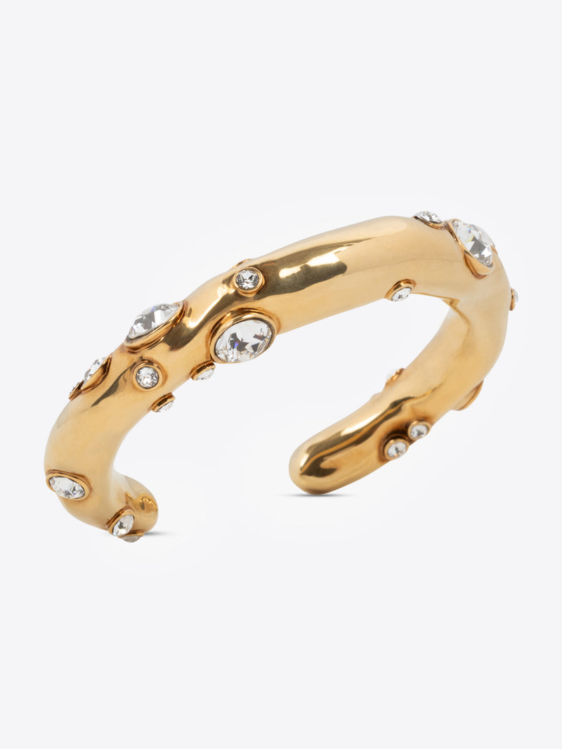 Gold ring with embedded crystals on a white background