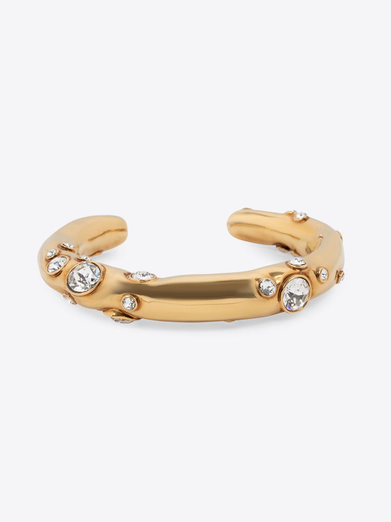Gold bracelet with embedded crystals on a white background