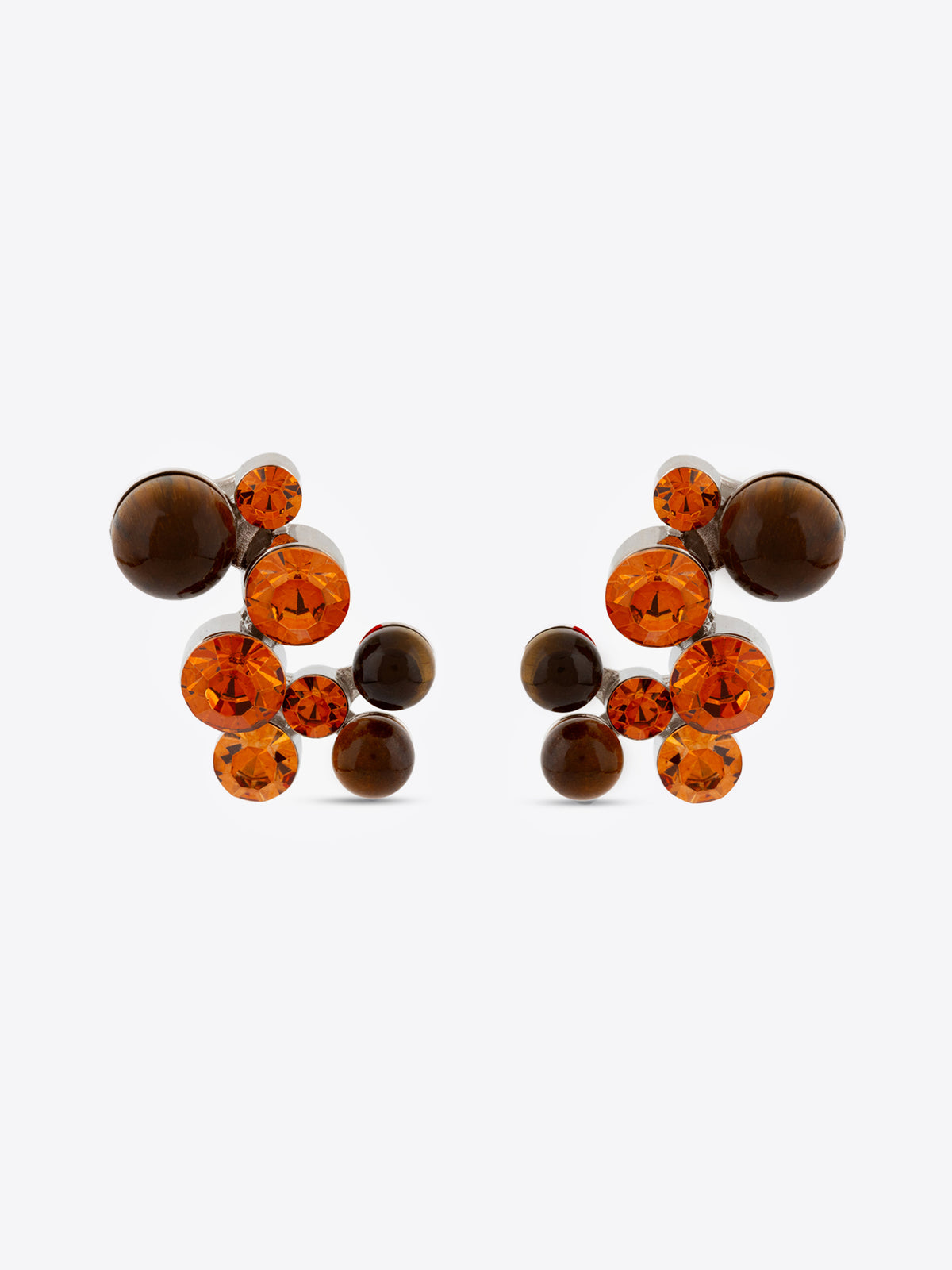 Pair of earrings with brown and orange gemstones on a white background