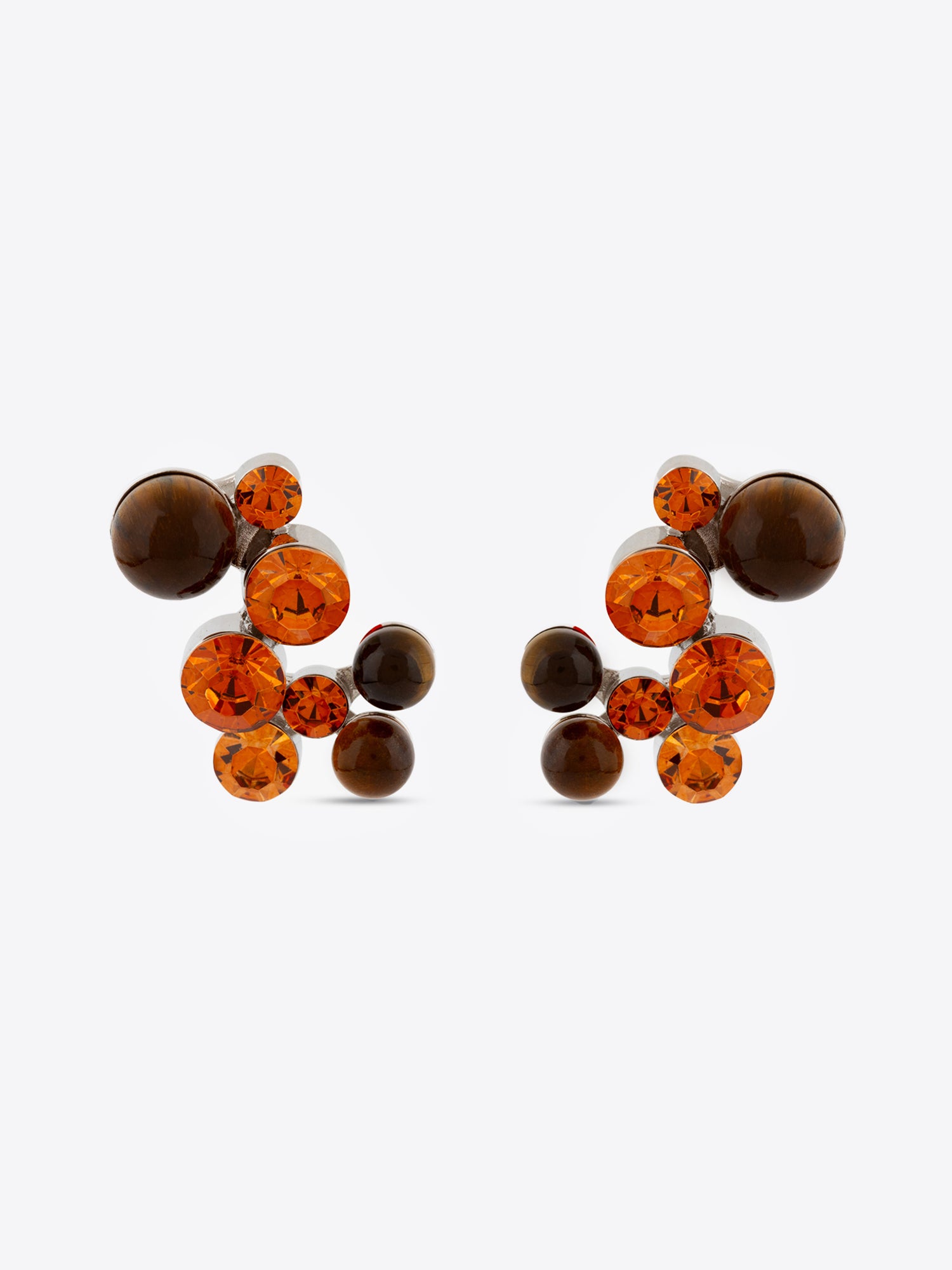 Pair of earrings with brown and orange gemstones on a white background