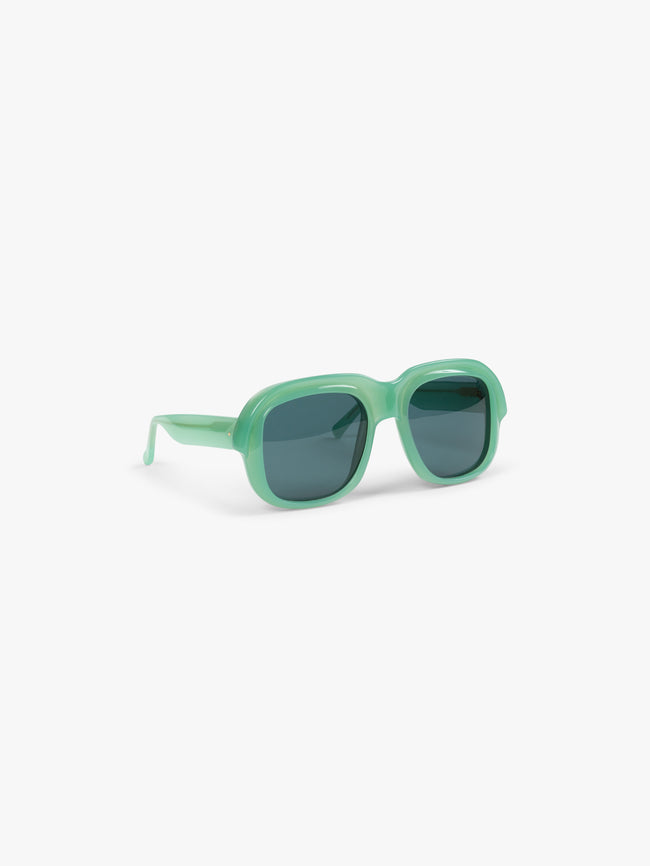 Green sunglasses on a white background