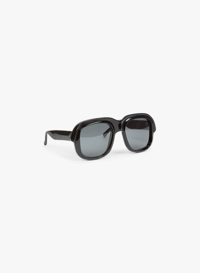 Black sunglasses with dark lenses on a white background - Dries Van Noten