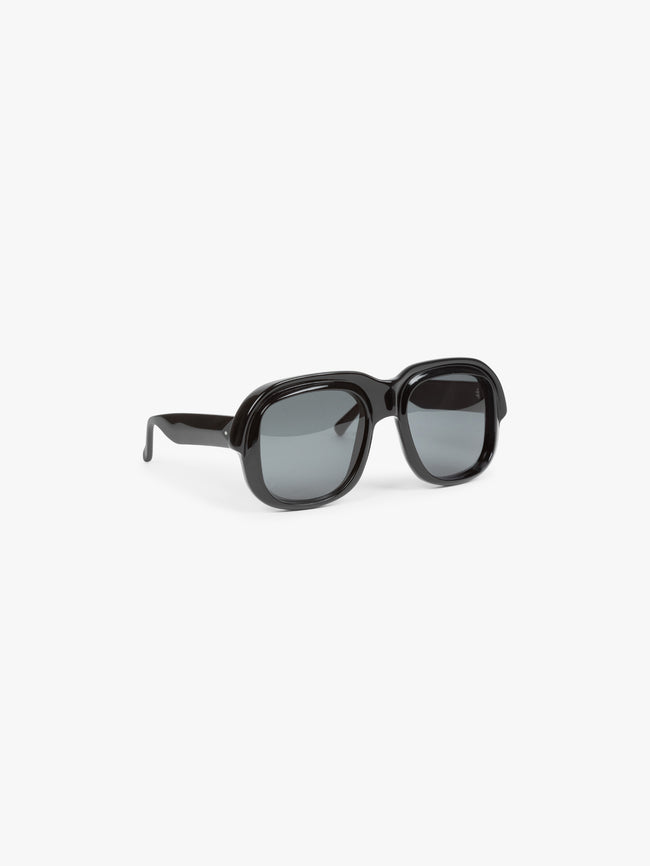 Black sunglasses with dark lenses on a white background