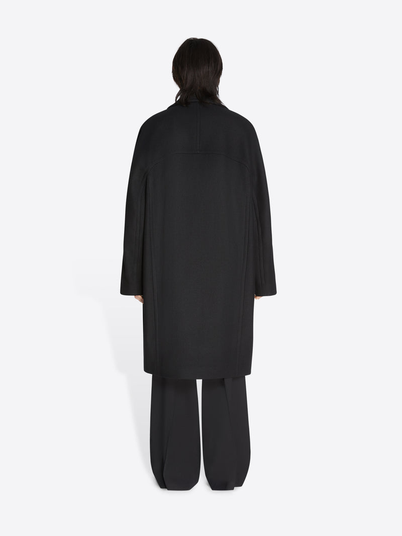 Person wearing a black outfit on a white background
