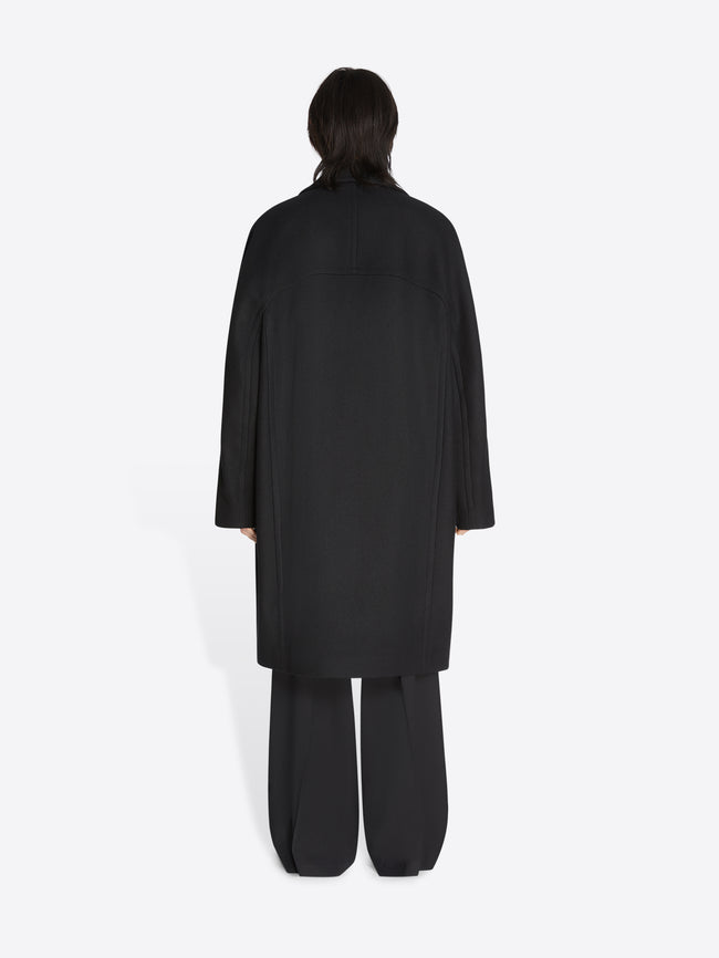 Person wearing a black outfit on a white background