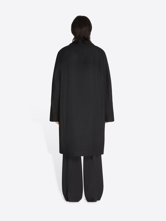 Person wearing a black outfit on a white background