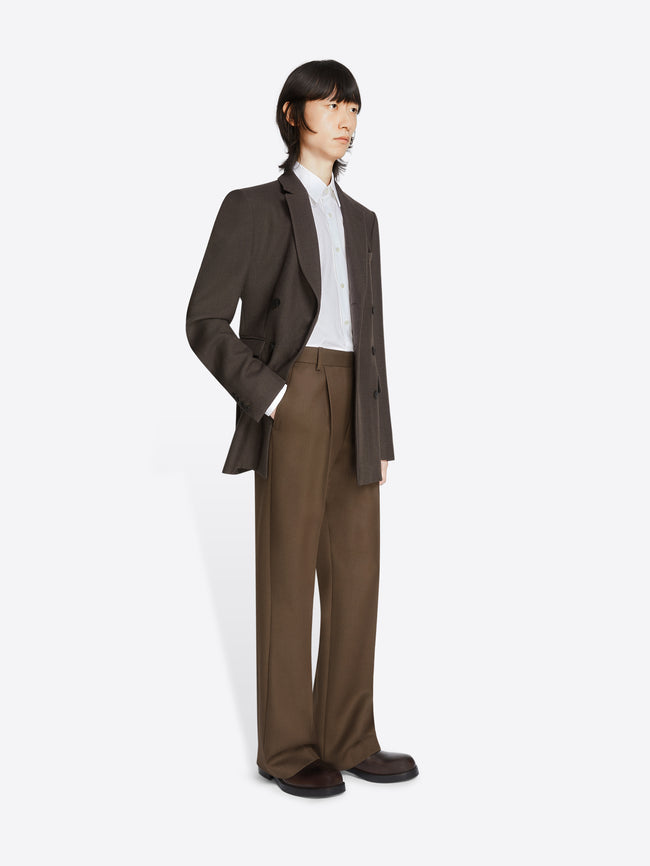 Model wearing a dark brown, regular fit wool blazer and lighter brown pants on a white background