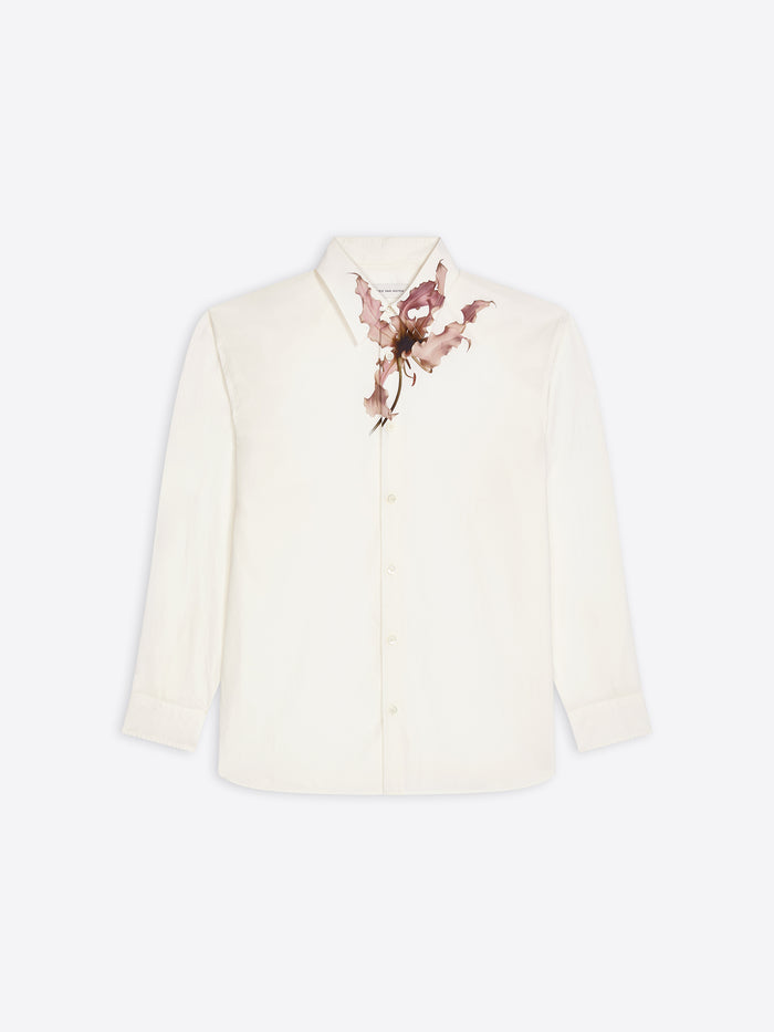 White, loose cotton shirt with a pink floral print on a white background