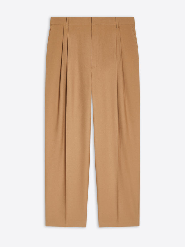 Tan colored pleated wool pants on a white background