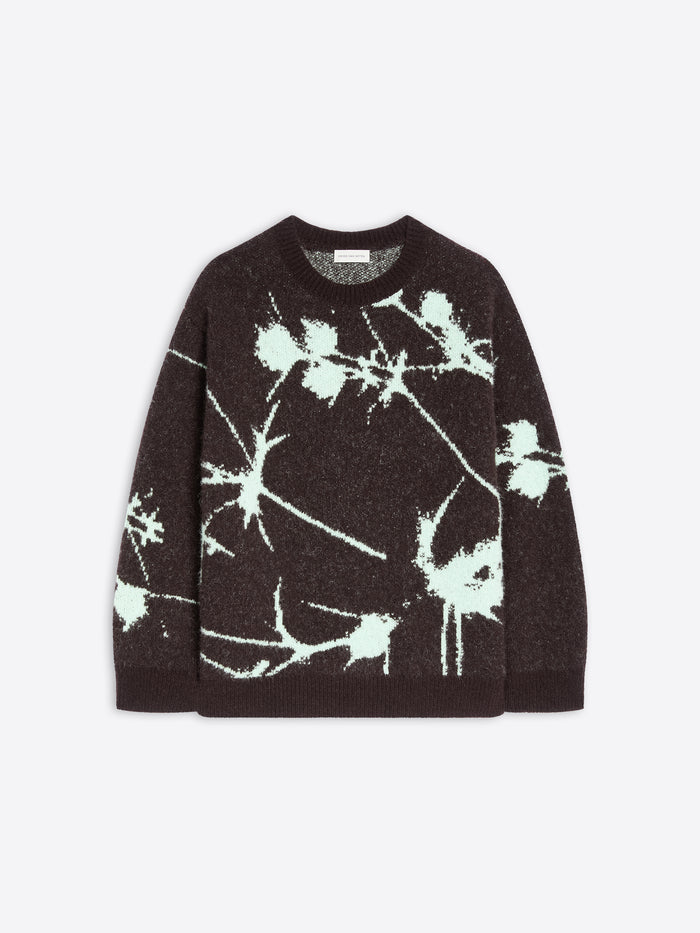 Black sweater with white abstract pattern on a light gray background