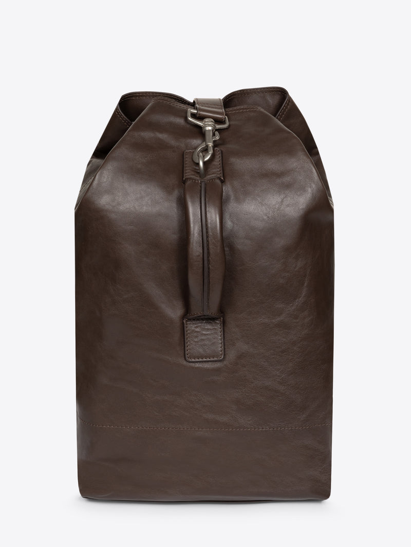 Brown, adjustable leather bag with a front clasp on a white background