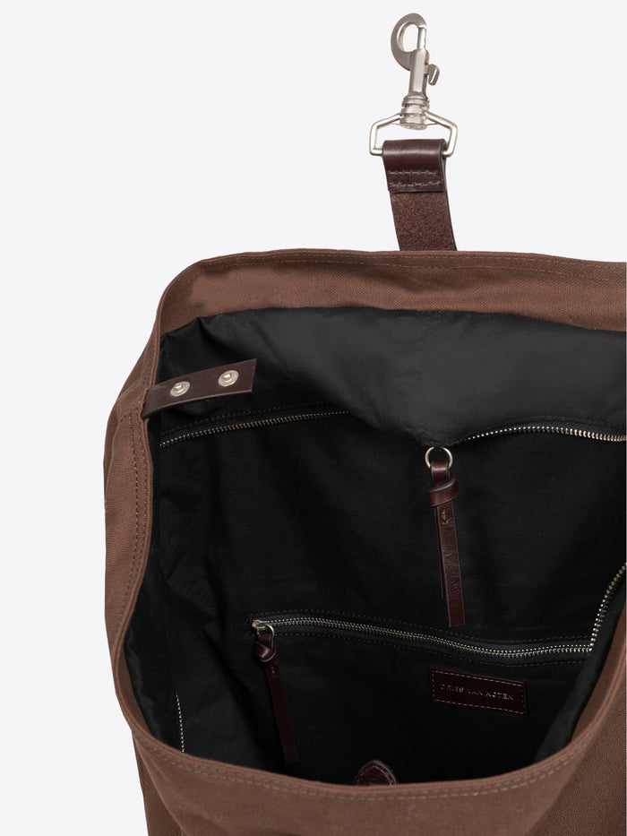 Inside of a brown duffel bag on a white background