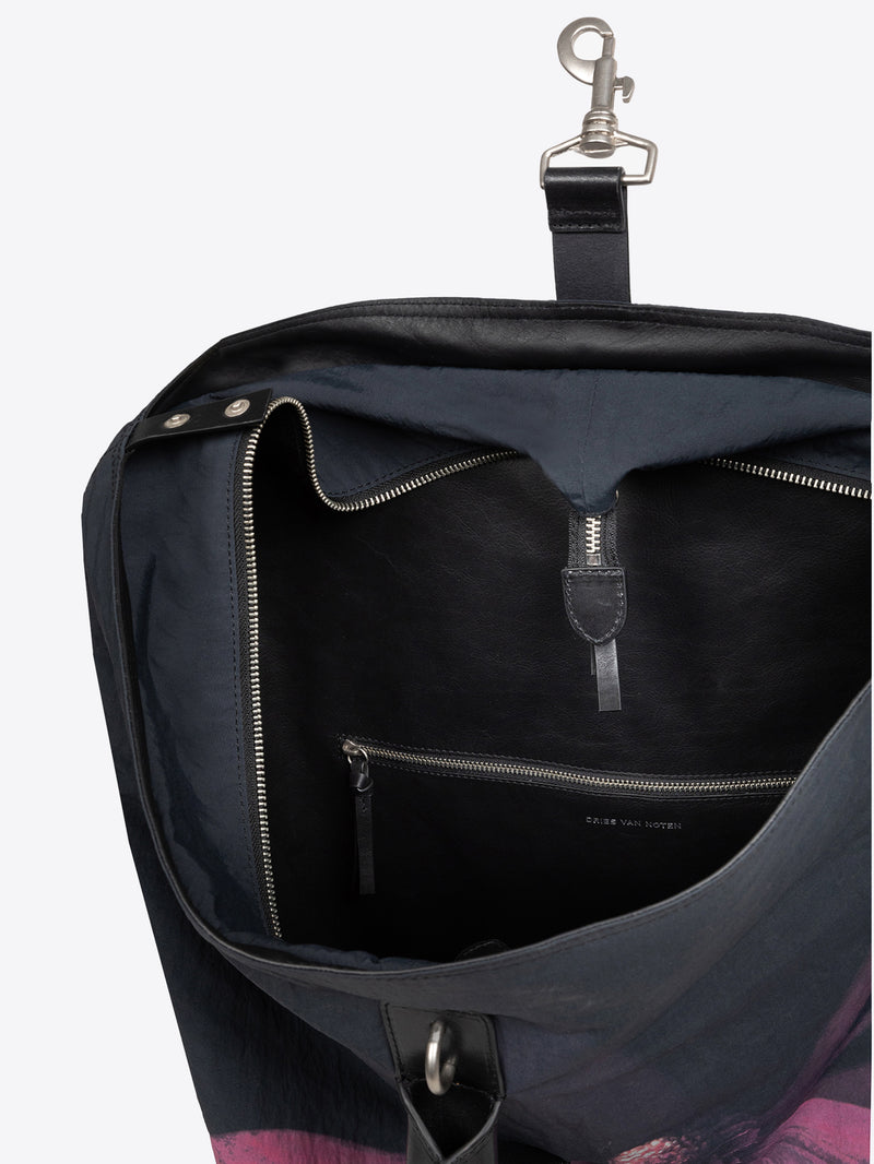 Inside close up bordeaux black duffel bag with a floral design on a white background.