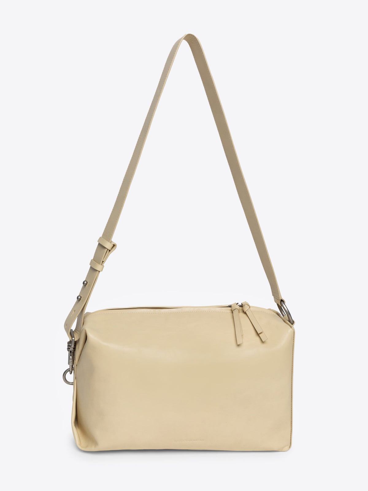 Sand colored handbag with a strap on a white background