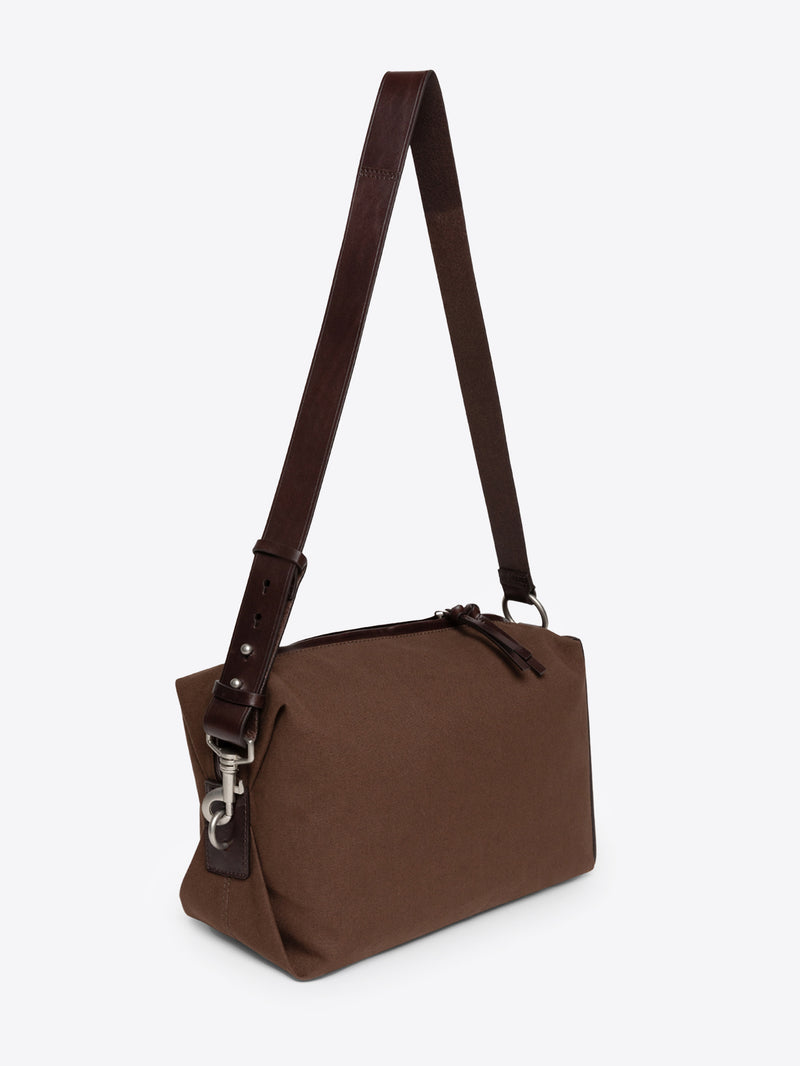 Dark brown shoulder bag with a strap on a white background