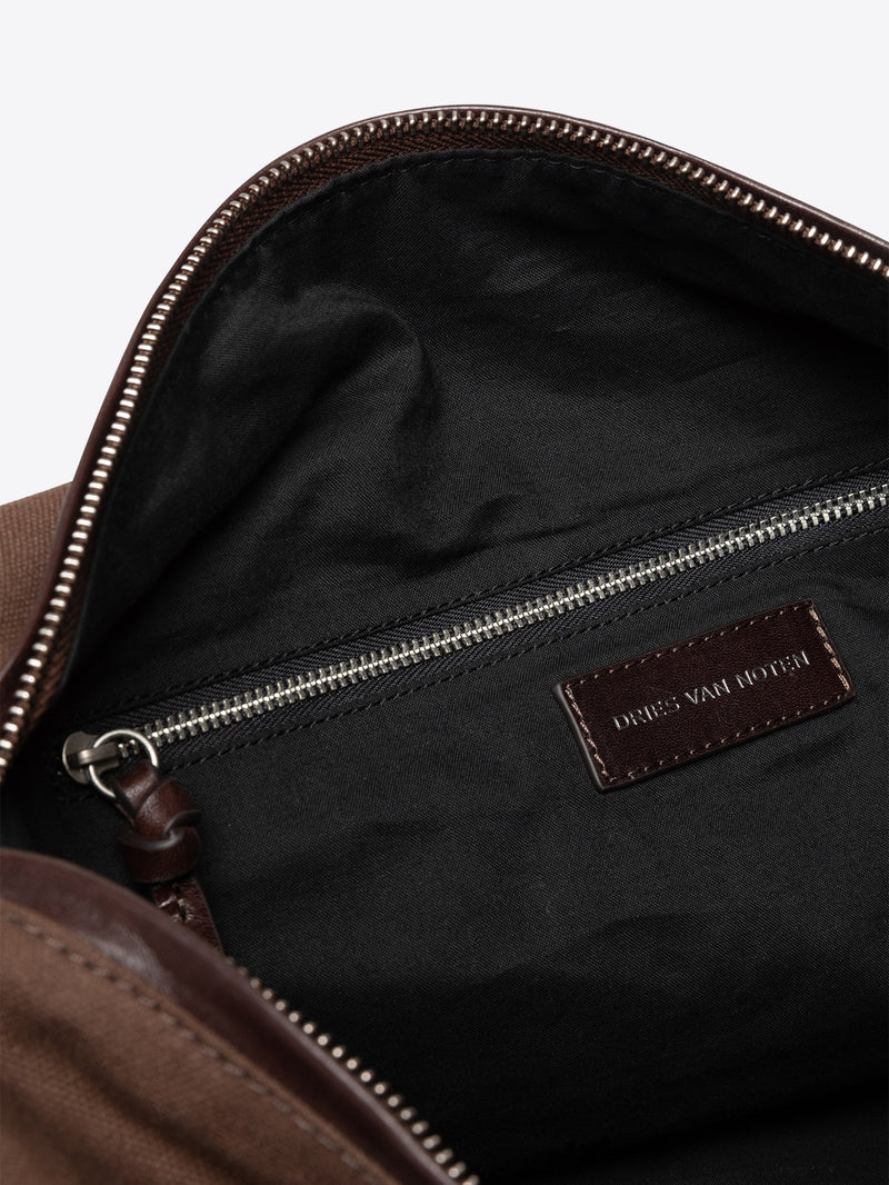Close-up of a dark brown bag with a visible Dries Van Noten label