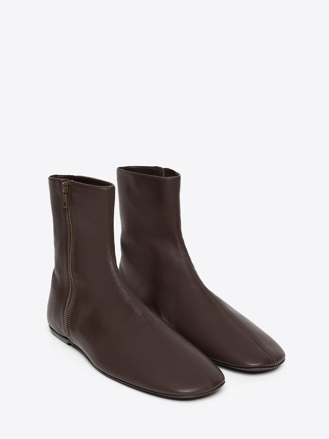 Pair of brown leather ankle boots with a zipper on a white background