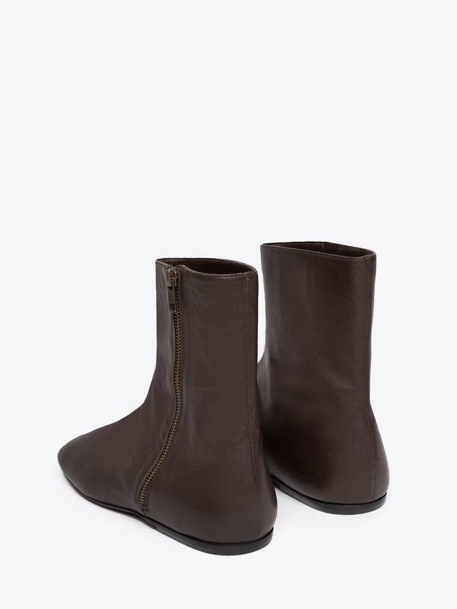 Pair of brown leather ankle boots with a zipper on a white background