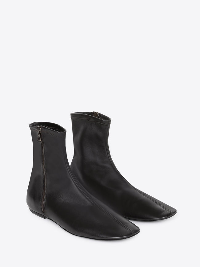 Pair of black leather ankle boots with a zipper on a white background